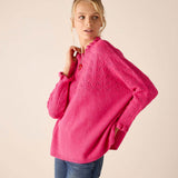 Fuchsia cable knit sweater with an oversized fit and textured stitch detail.