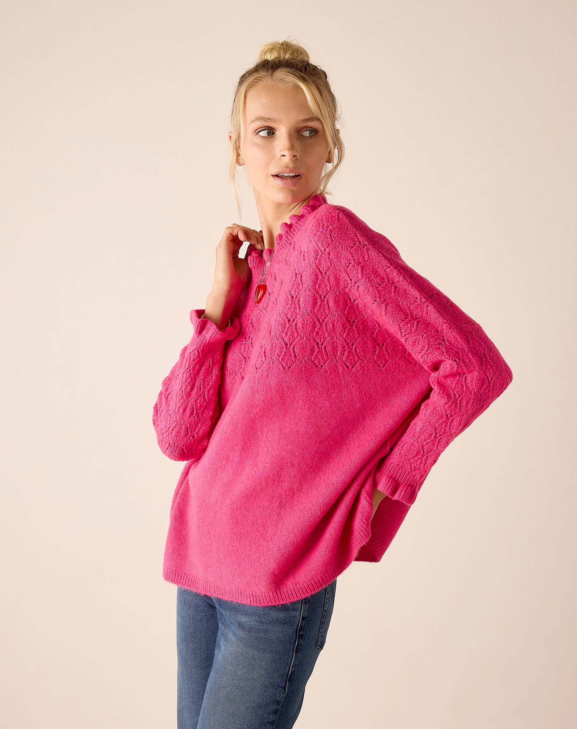 Fuchsia cable knit sweater with an oversized fit and textured stitch detail.