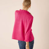 Back view of women's travel-friendly fuchsia knit poncho with open lace detailing.