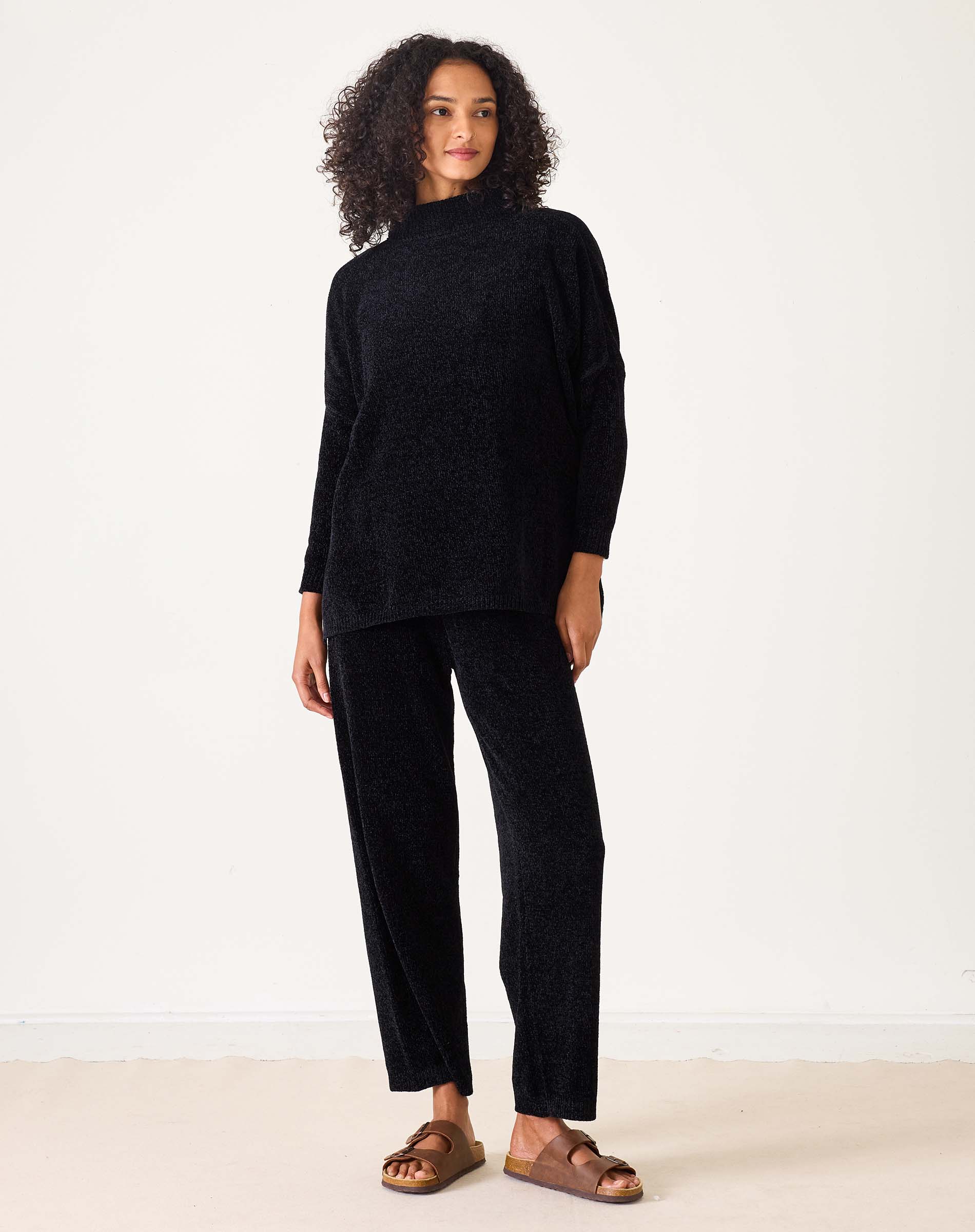Ladies' travel-ready black chenille knit sweater with a relaxed fit and long sleeves.