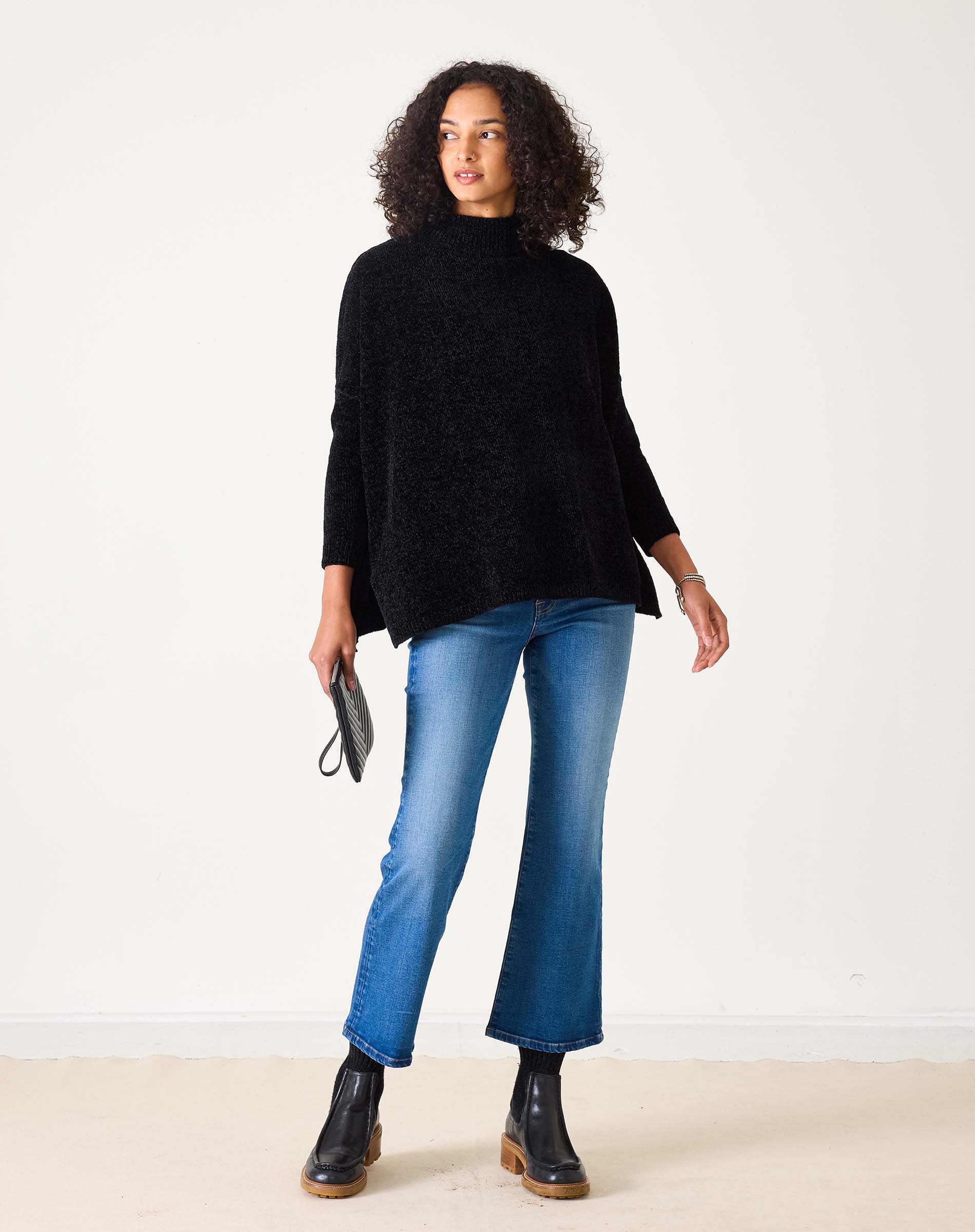 Black oversized chenille sweater with a high neck.