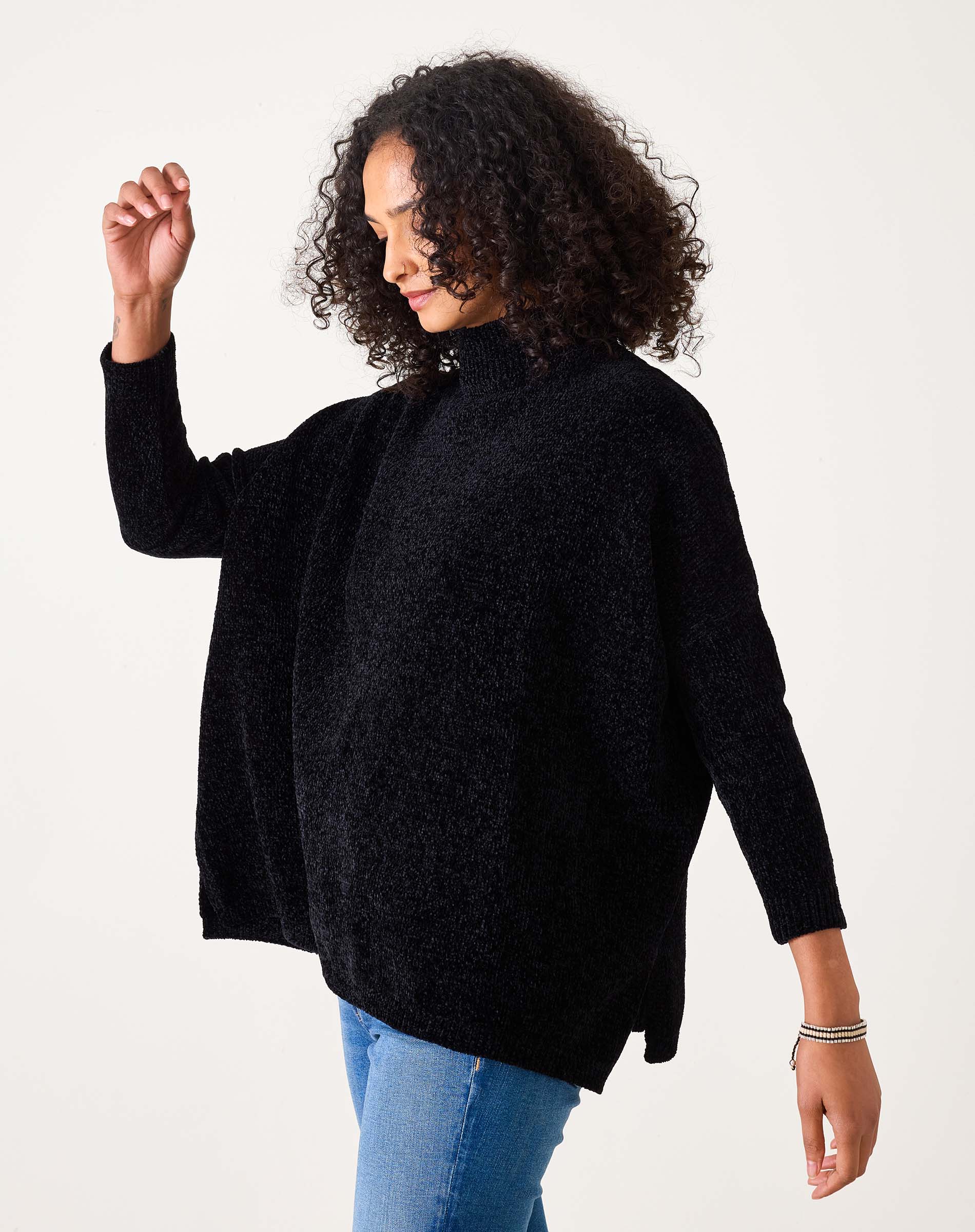 Black chenille knit sweater with a cozy oversized fit and high neckline.