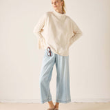 Women's travel-friendly cream mockneck knit sweater with a relaxed fit.