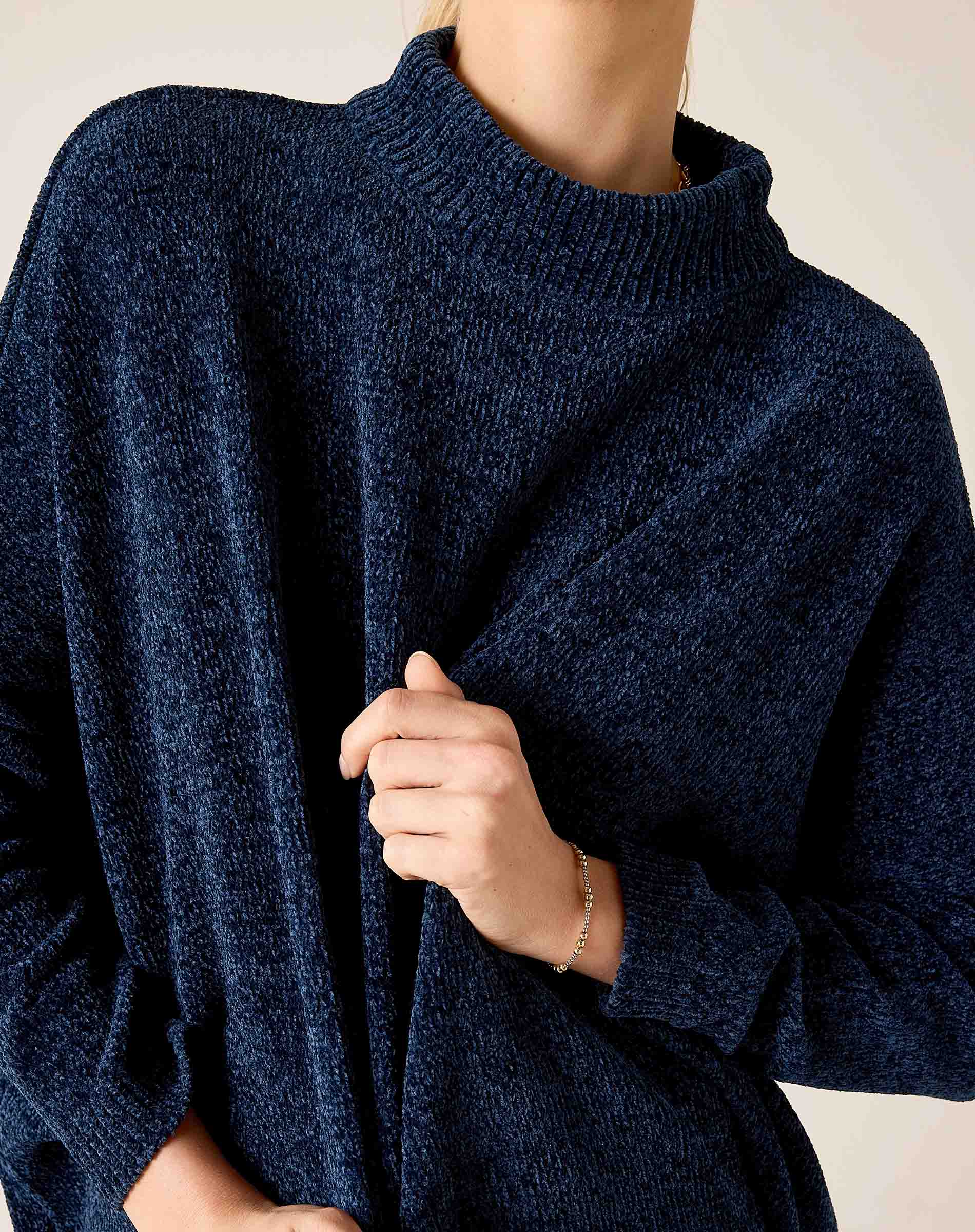 Navy blue mockneck knit top with a soft, textured weave.
