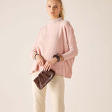 Women's travel-friendly ballet pink mockneck sweater in a soft knit fabric.