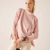 Ballet pink mockneck knit sweater with a relaxed fit and ribbed detail.