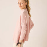 Ballet pink mockneck knit sweater with ribbed cuffs and hem.