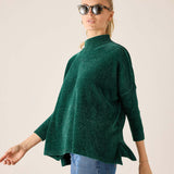 Everglade green mockneck sweater in a soft knit fabric with flared hem.