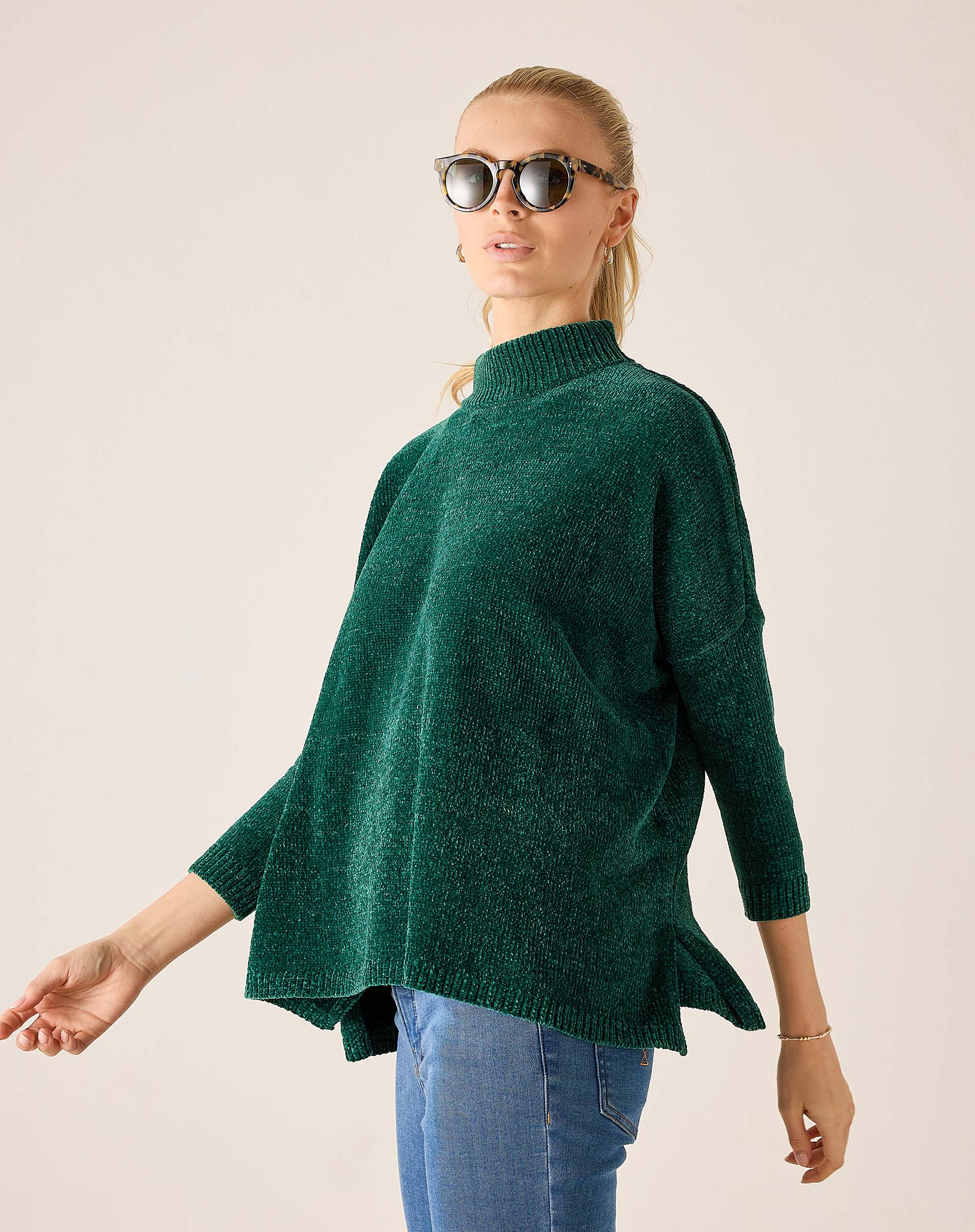 Everglade green mockneck sweater in a soft knit fabric with flared hem.
