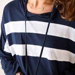 Navy and white striped hoodie worn by a person