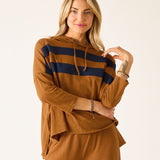 Woman wearing a brown hoodie with navy stripes and matching pants on a white background