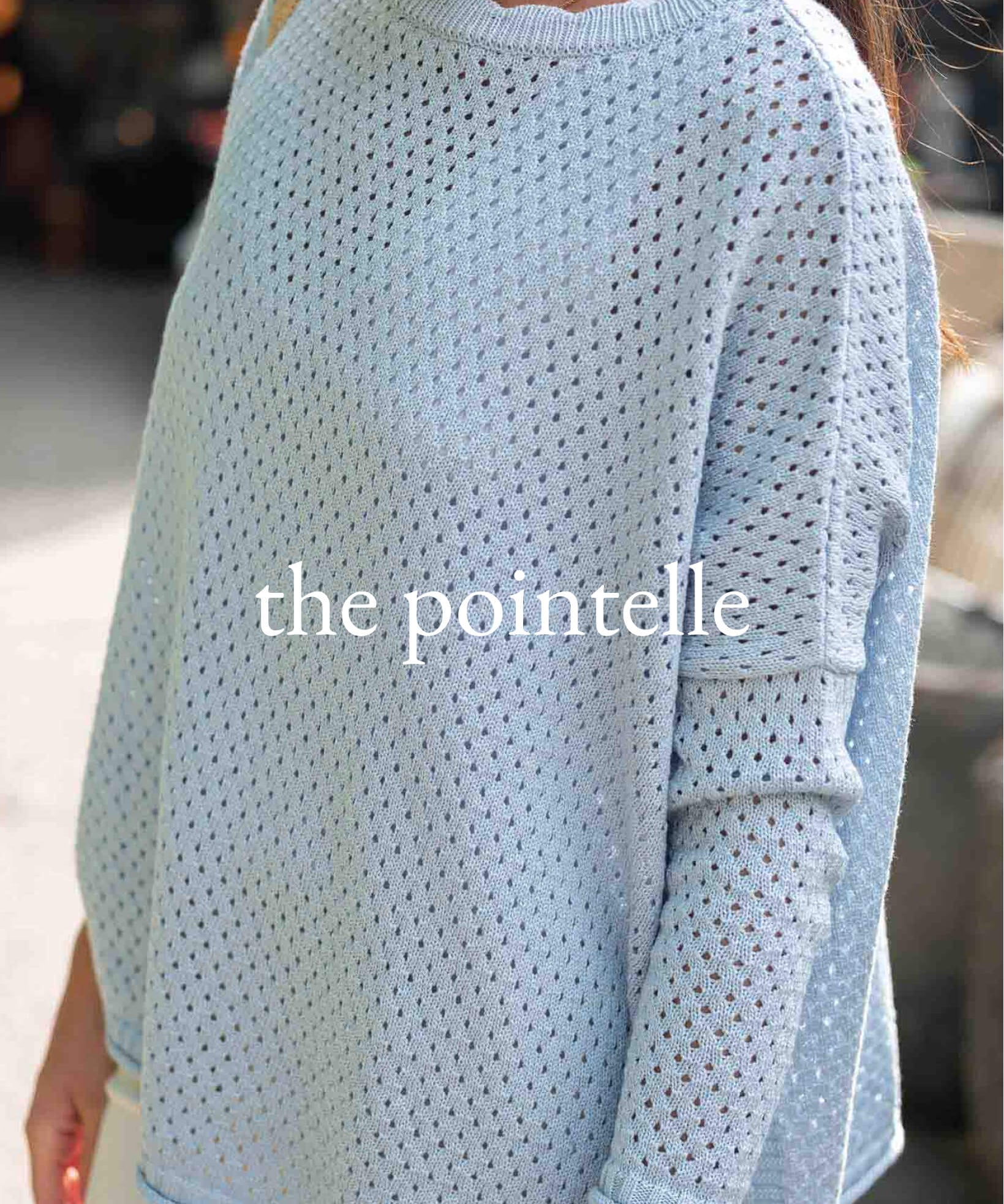 Light blue pointelle sweater with 'the pointelle' branding.
