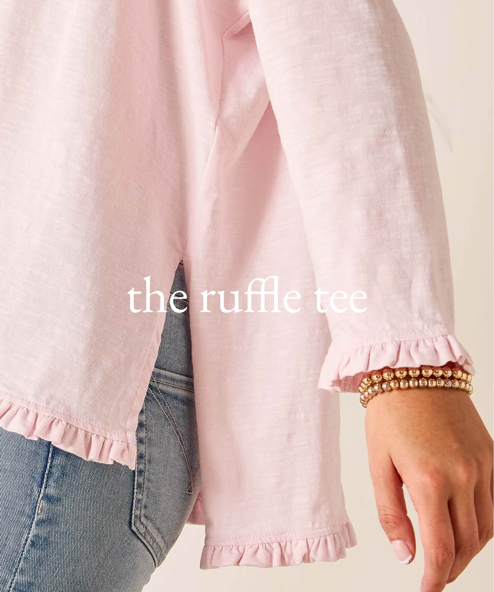 Pink ruffled shirt worn by a person with text 'the ruffle tee' on a light background