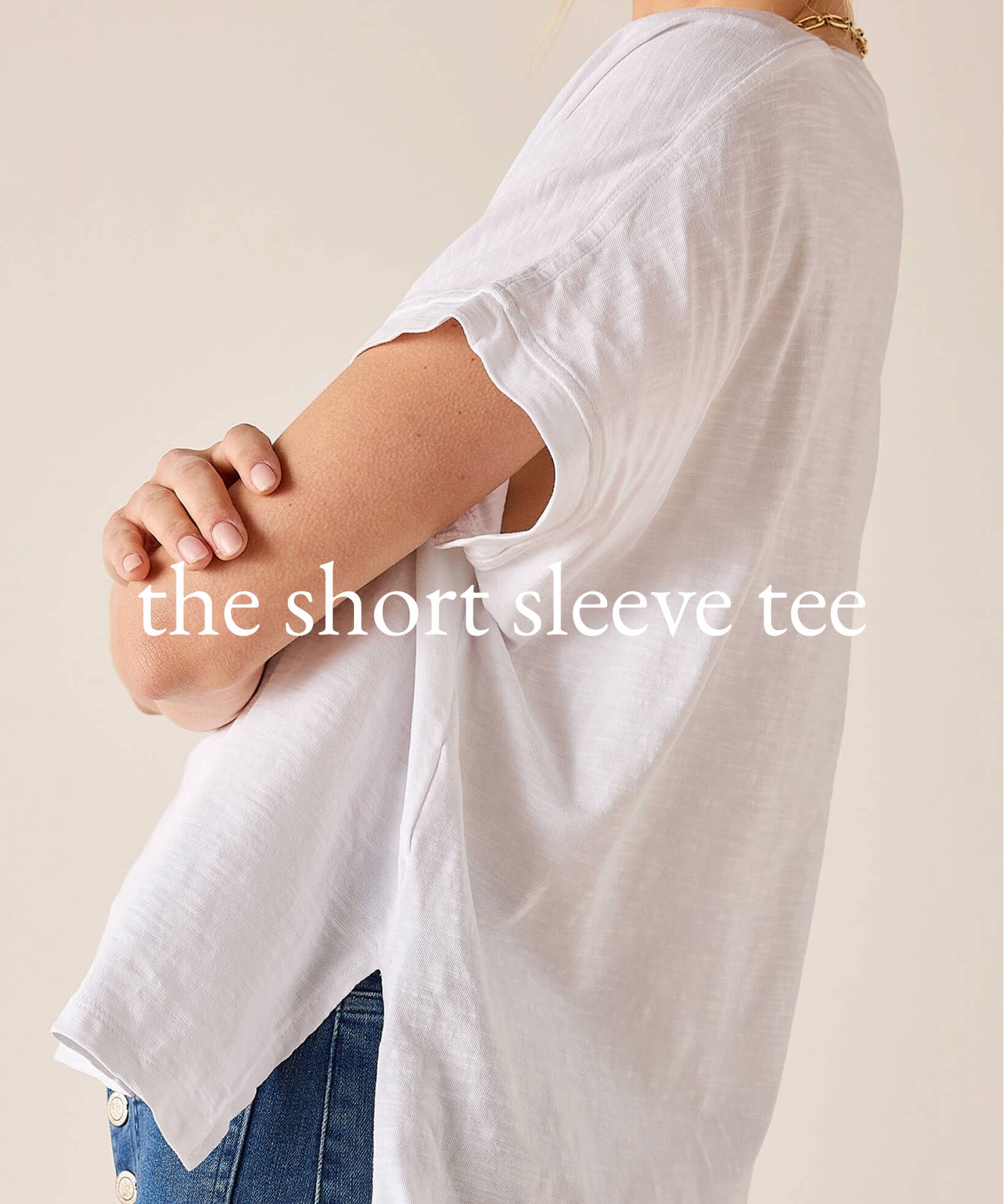 White short-sleeve tee worn by a person on a beige background with text overlay.