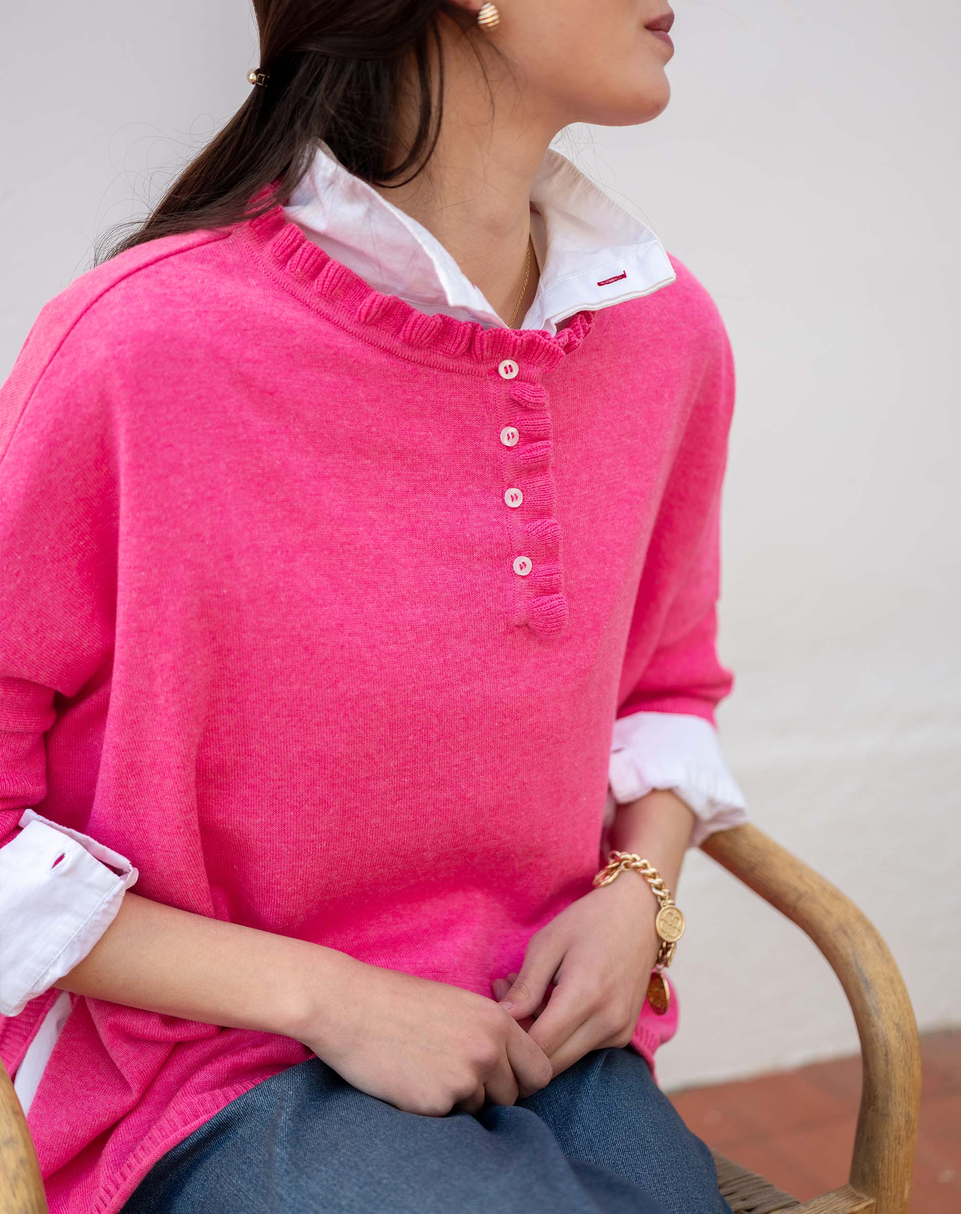 MERSEA ladies' travel-ready fuchsia ruffled henley knit top with button details and white undershirt.