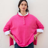 Fuchsia ruffle henley knit top with a buttoned chest and white lining.