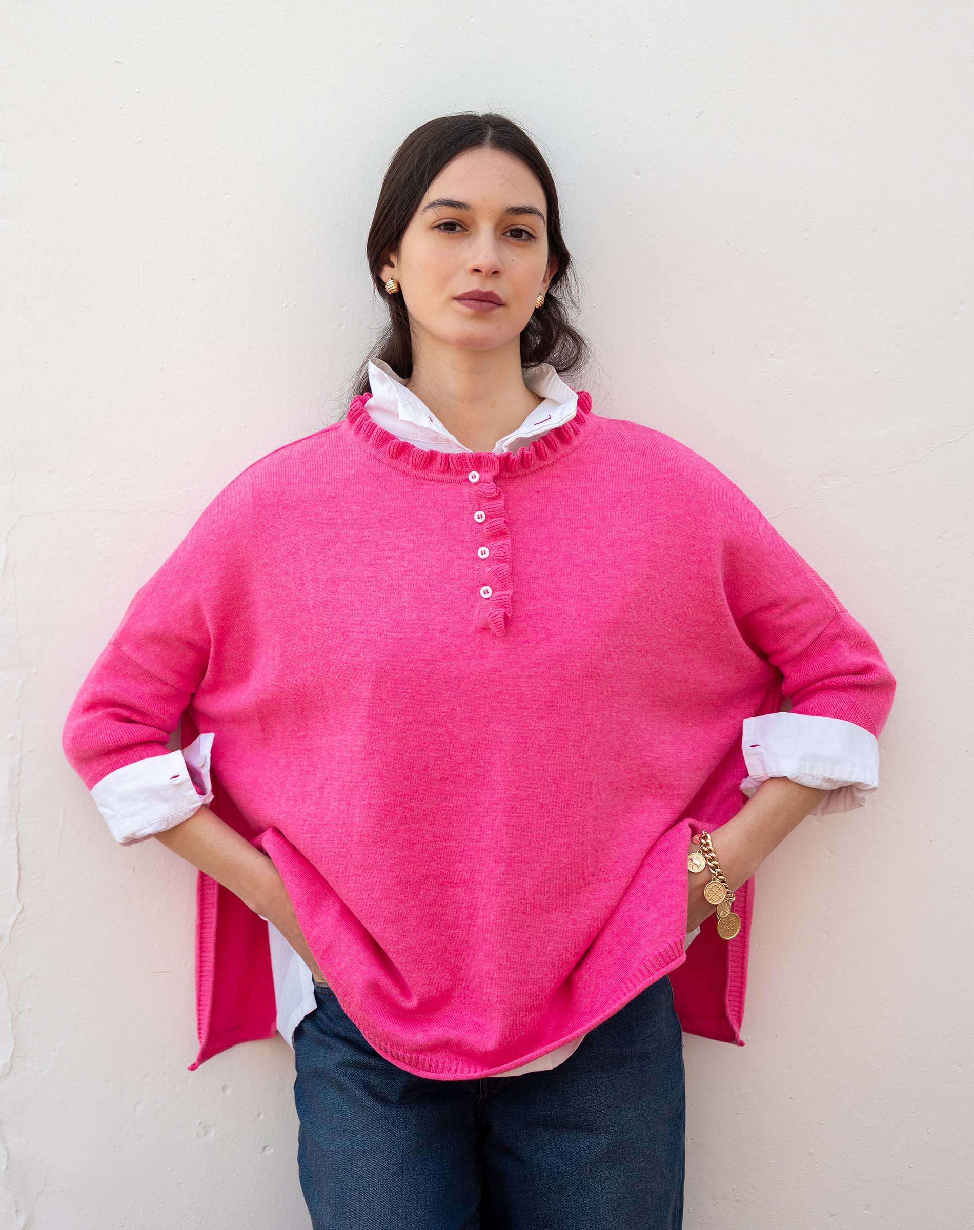 Fuchsia ruffle henley knit top with a buttoned chest and white lining.