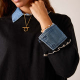 Black knit sweater with a denim-style collar and ruffled cuffs.