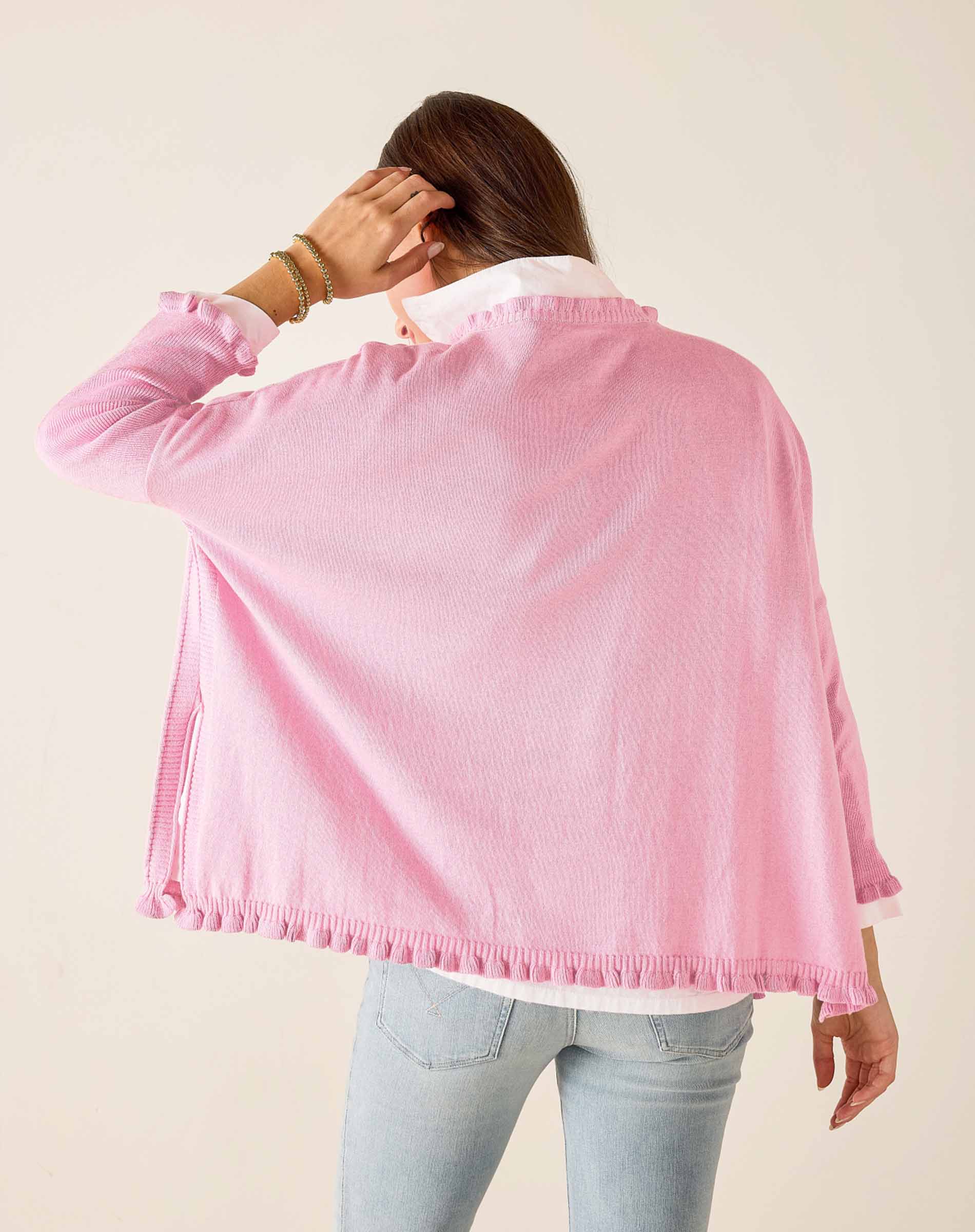 Person wearing a pink jacket with a plain background