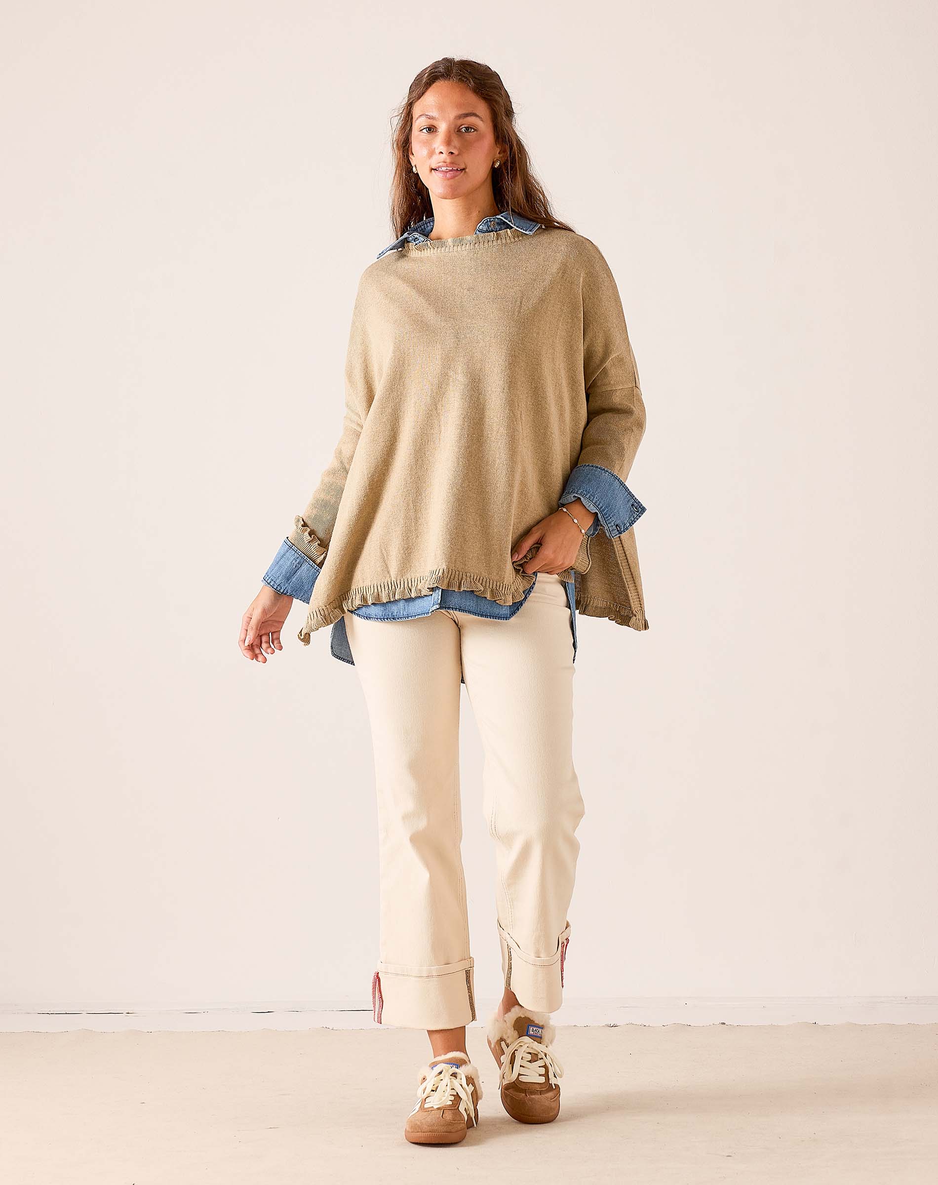 Saddle colored ruffled knit sweater featuring a relaxed fit and a layered look over a button-down shirt.