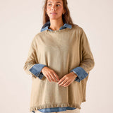 Saddle brown oversized knit sweater featuring a layered denim shirt look with ruffled hem and wide sleeves.