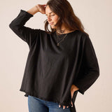Black relaxed-fit cotton tee with ruffle detailing at the hem and cuffs.
