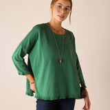 MERSEA ladies' travel-ready fairway green ruffle tee with 3/4 sleeves and a ruffled hem.