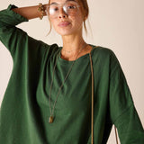 Fairway green ruffle tee with wide sleeves and soft texture.