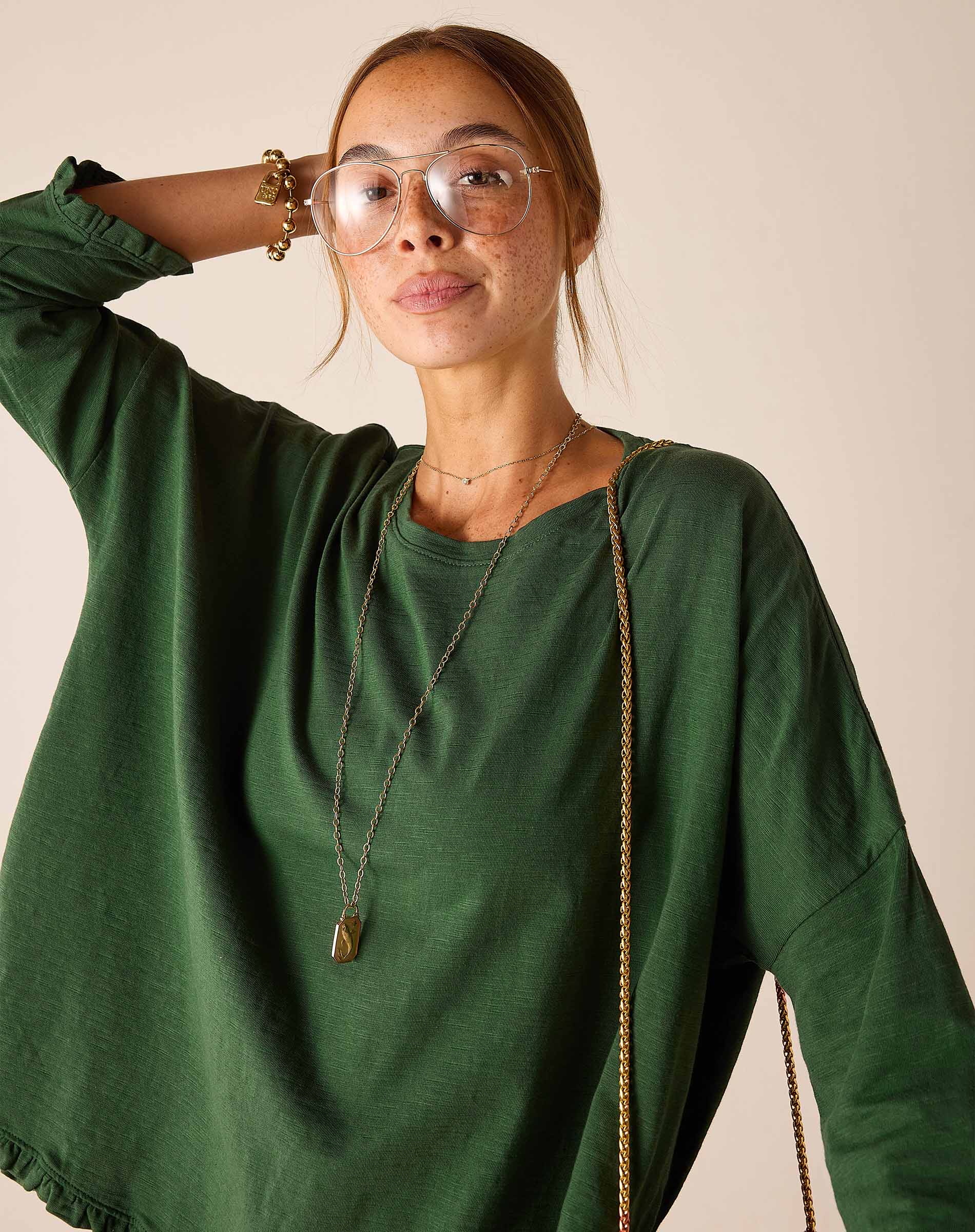 Fairway green ruffle tee with wide sleeves and soft texture.