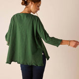 Back view of the fairway green ruffled tee with relaxed fit and loose sleeves.
