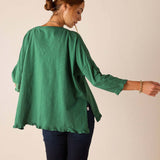 Back view of the fairway green Catalina ruffle tee featuring a relaxed fit and ruffled hem.