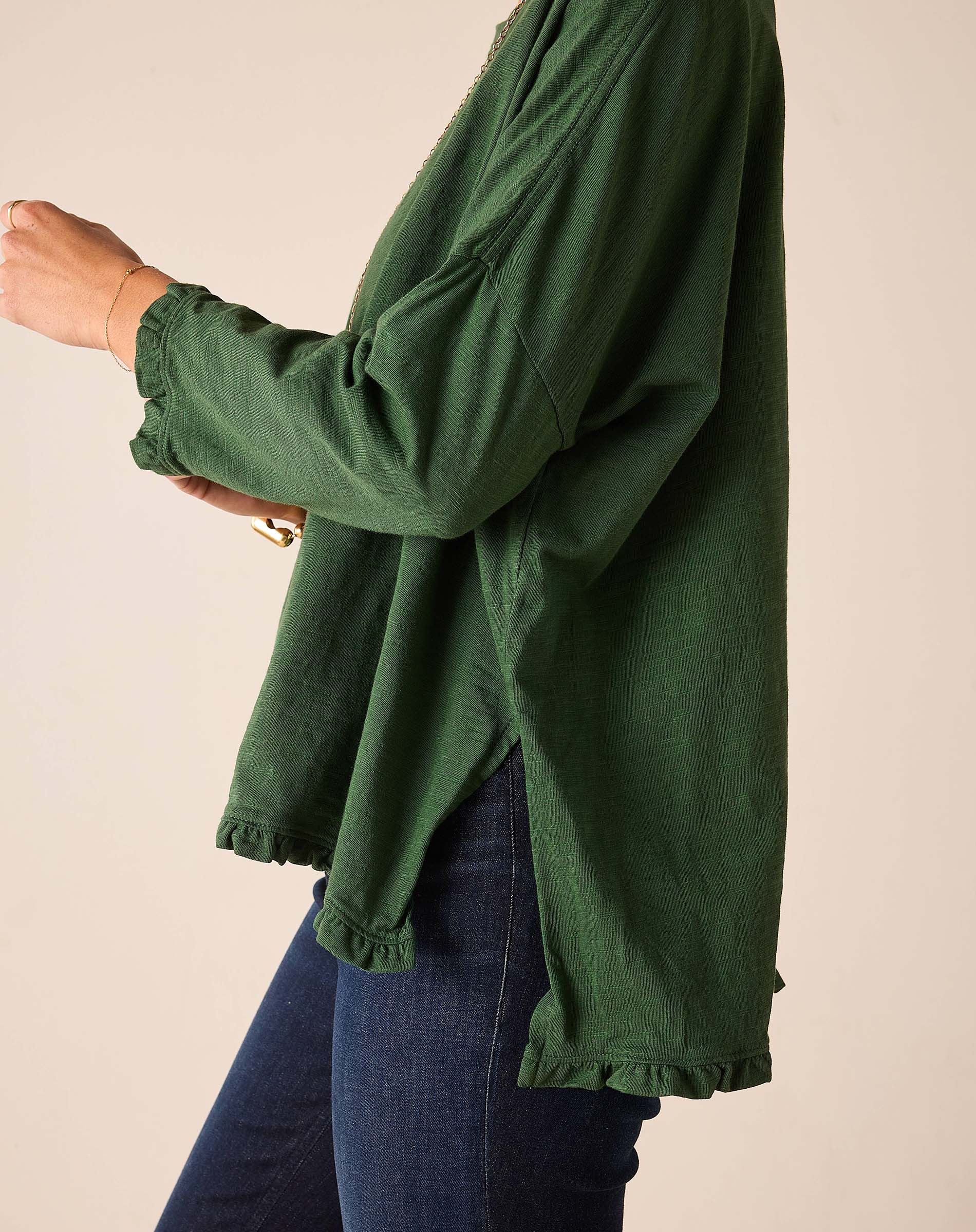 Fairway green ruffled tee with a relaxed fit and long sleeves.