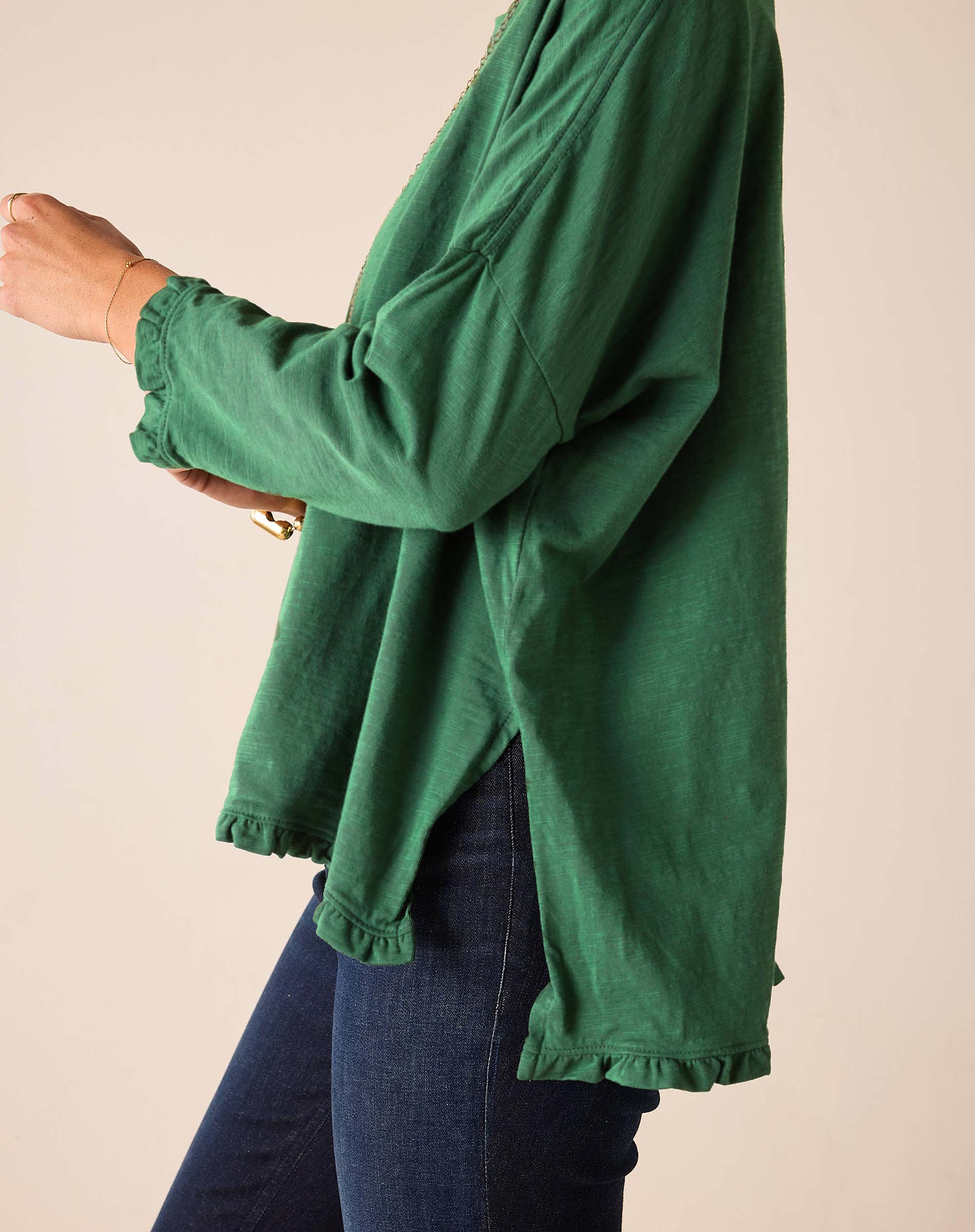 Fairway green ruffled tee with long sleeves and a flared hem.