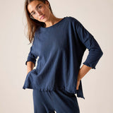 Woman wearing a blue outfit against a plain background