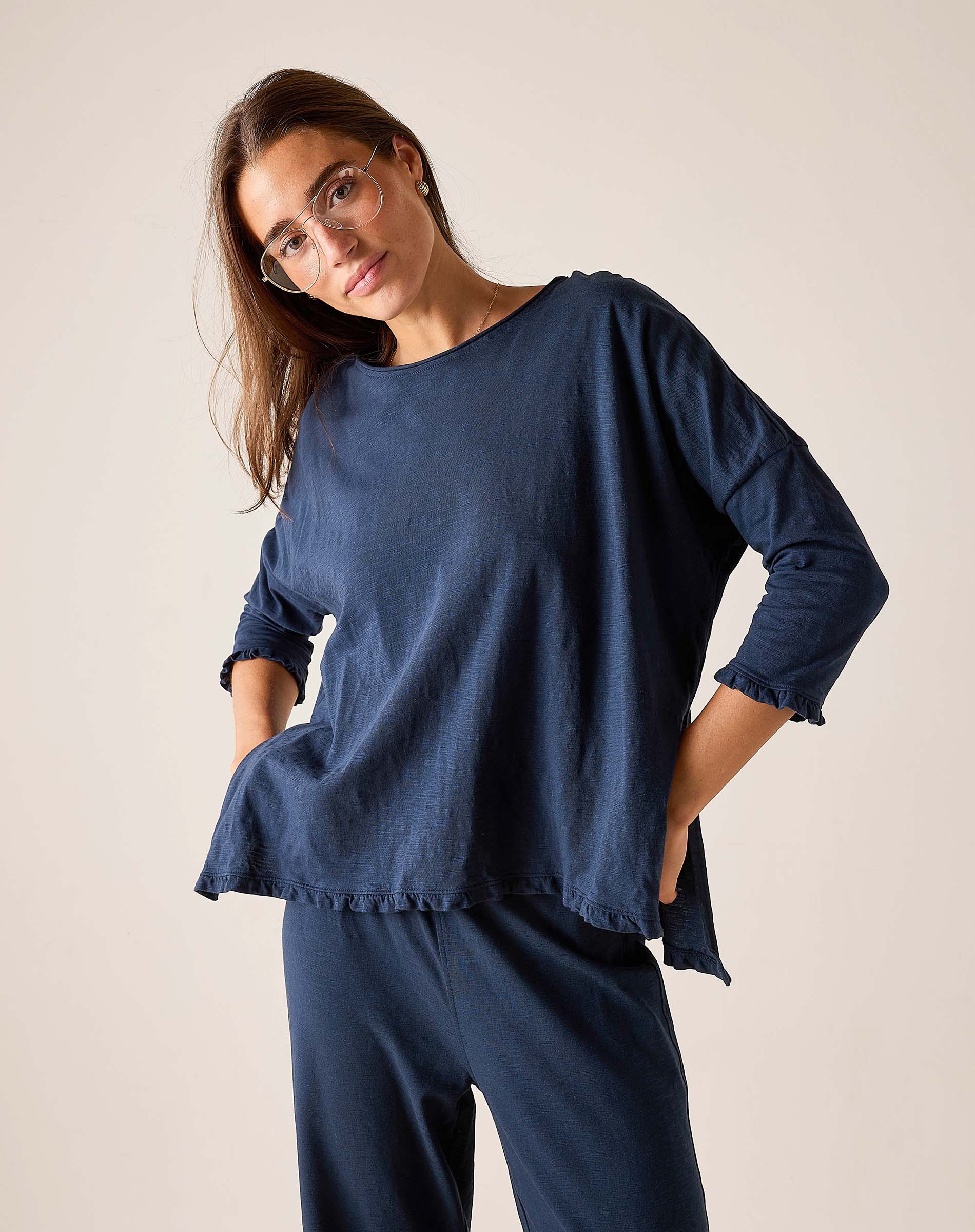 Woman wearing a blue outfit against a plain background
