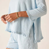 Light blue long-sleeve top and shorts set on a neutral background