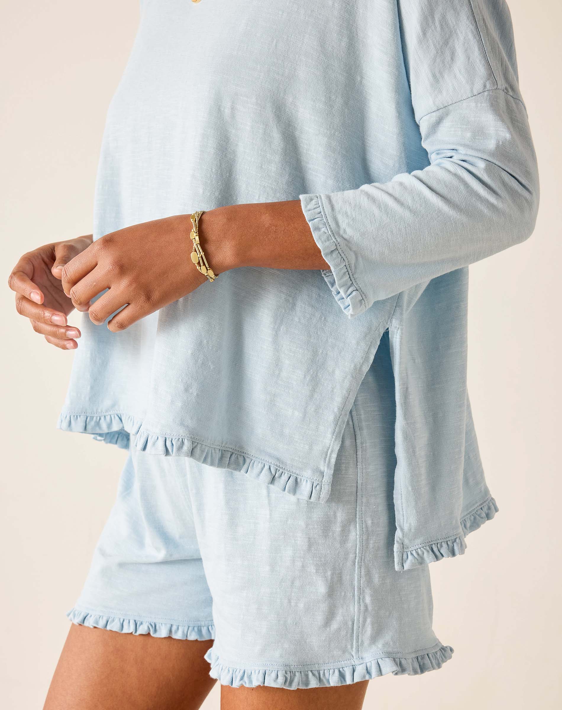 Light blue long-sleeve top and shorts set on a neutral background