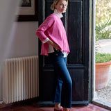 MERSEA ladies' travel-ready rapture rose ruffled tee with a pleated neckline and flared sleeves.