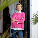 Ruffled tee in rapture rose with a ruffled hem and long sleeves.