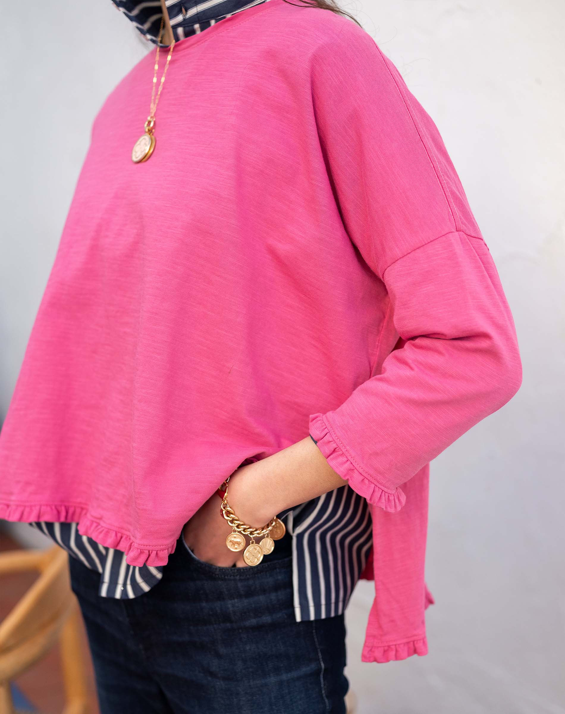 Rapture Rose ruffled tee with a relaxed fit and ruched details at the hem and sleeves.