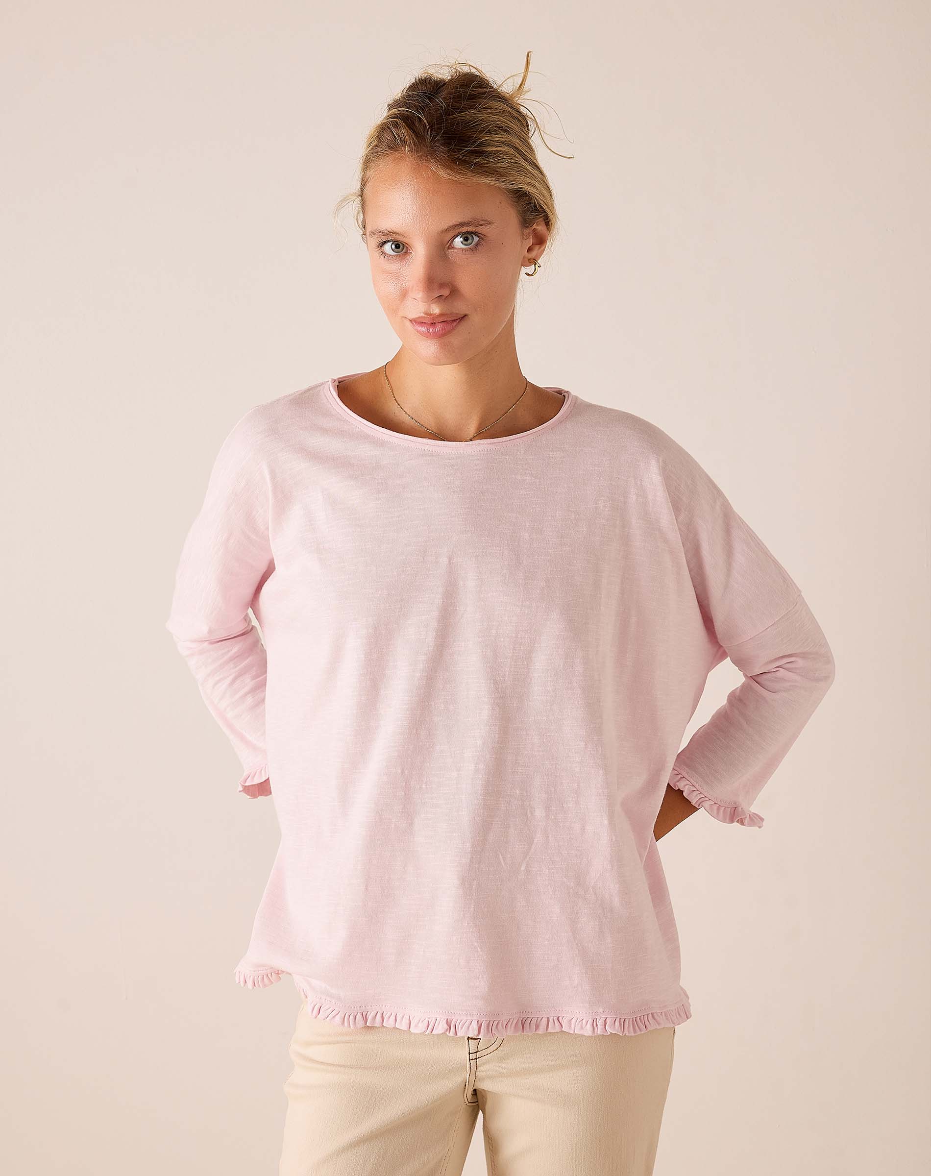 MERSEA women's travel-friendly rose quartz long-sleeve tee in a soft knit with ruffled trim at the hem and cuffs.