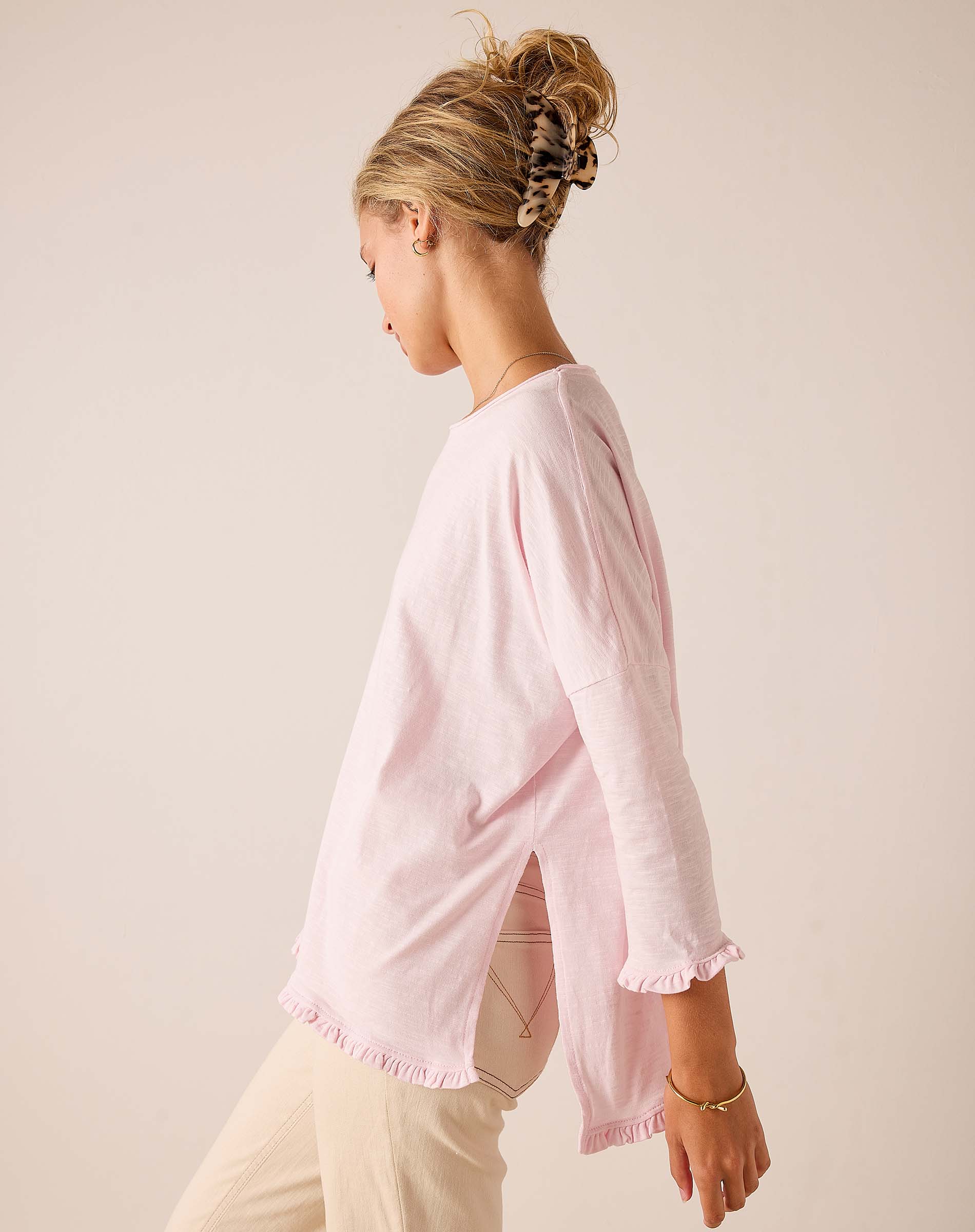 side view of women's travel-friendly rose quartz relaxed-fit cotton-blend t-shirt with ruffled hem and sleeves