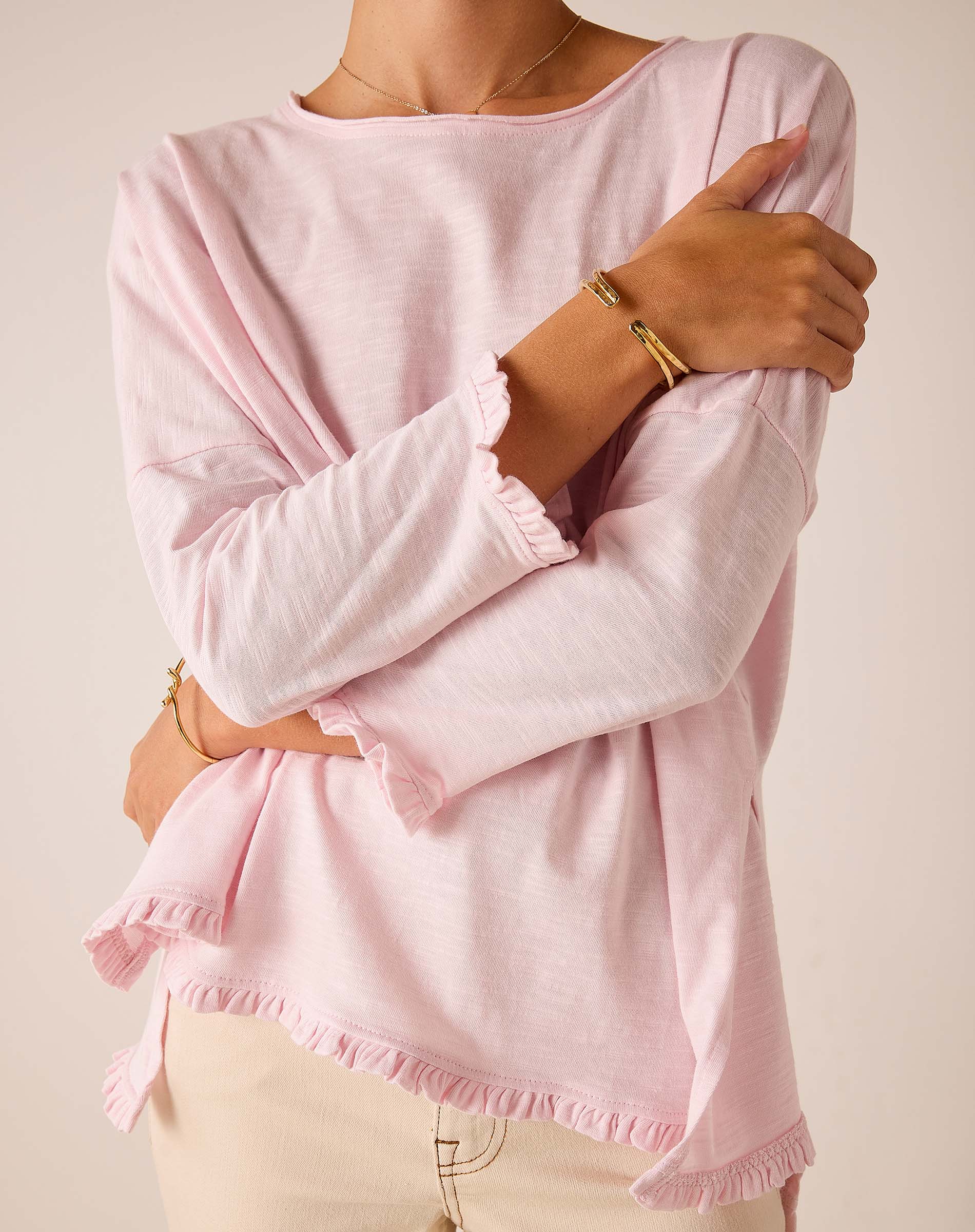 Rose quartz loose-fit cotton t-shirt with ruffle details on the sleeves and hem.