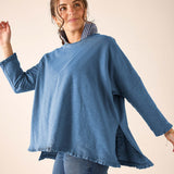 Slate blue loose fit cotton blend ruffle tee with ruffled hem and side slits.
