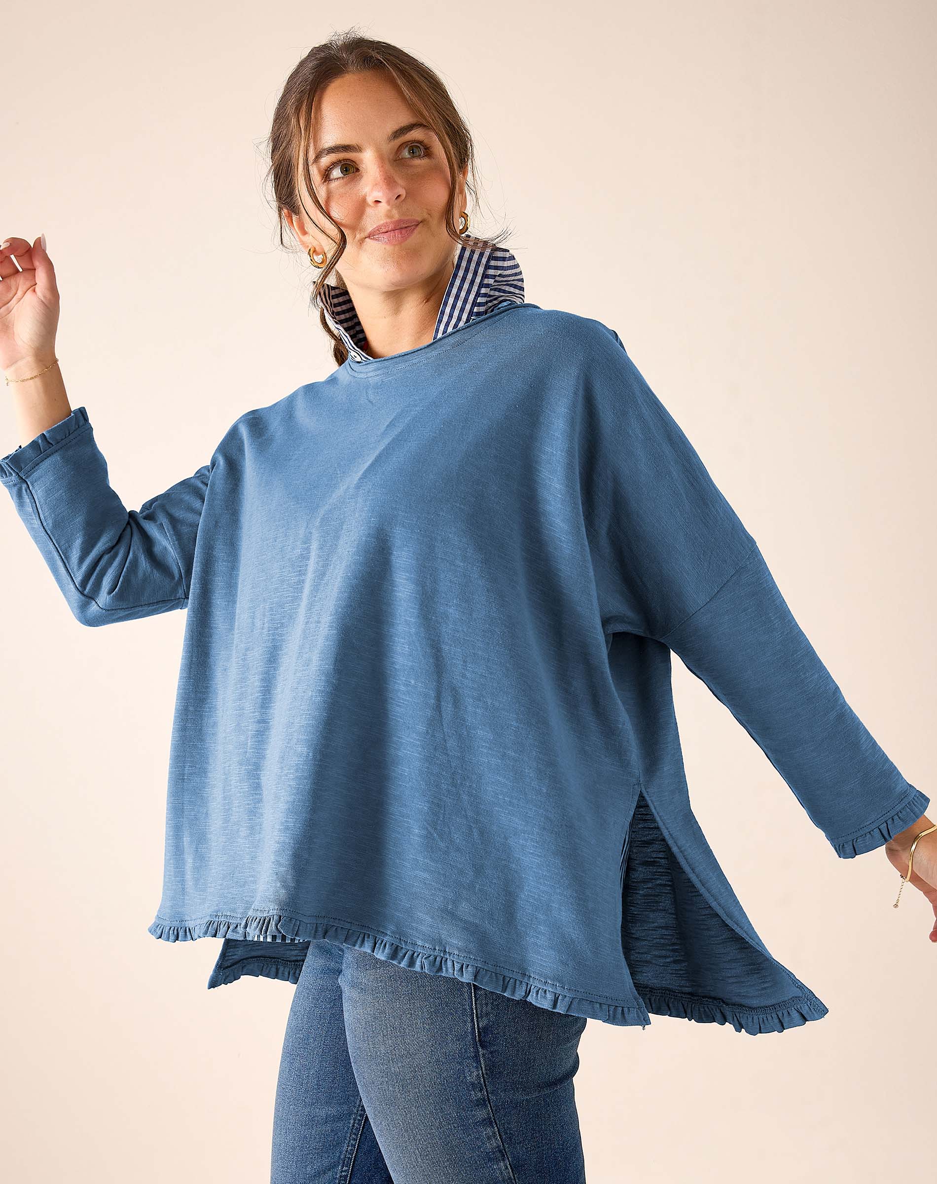 Slate blue loose fit cotton blend ruffle tee with ruffled hem and side slits.