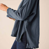 Slate blue ruffle tee with long sleeves and a ruffled hem.