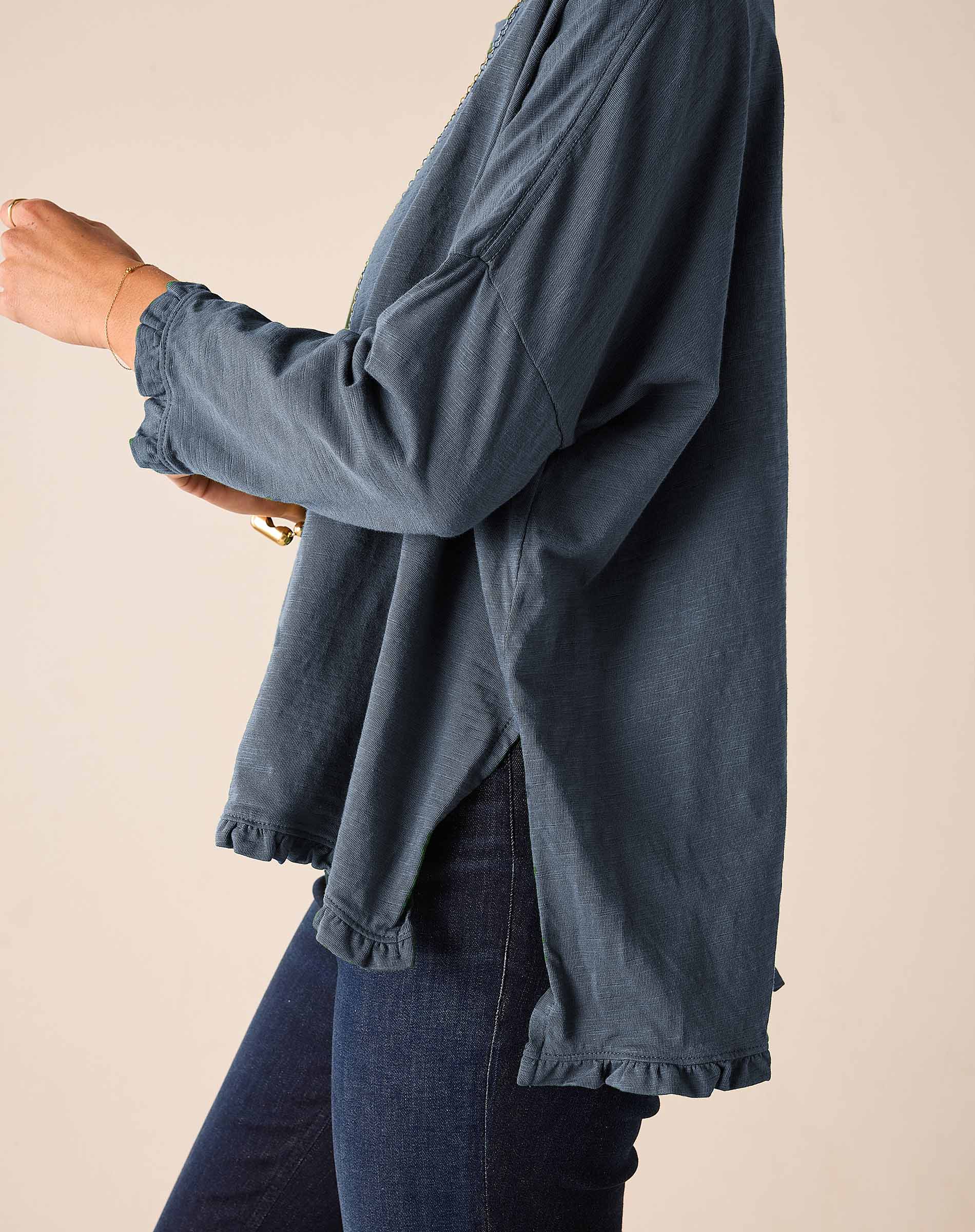Slate blue ruffle tee with long sleeves and a ruffled hem.