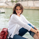 Woman sitting by a river with a blurred background