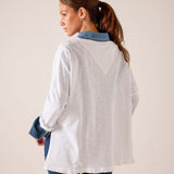 White relaxed-fit cotton tee with blue contrast collar and ruffled hem