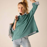 Ladies' travel-ready aqua blue loose-fit tee with rolled sleeves and layered lining.